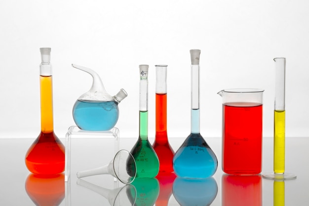 Free photo lab glassware with colored liquids arrangement