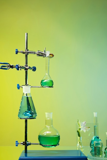 Free photo laboratory glassware assortment with green liquids