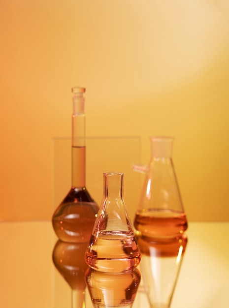 Laboratory glassware assortment with orange liquids