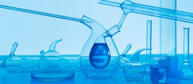 Laboratory glassware on blue background