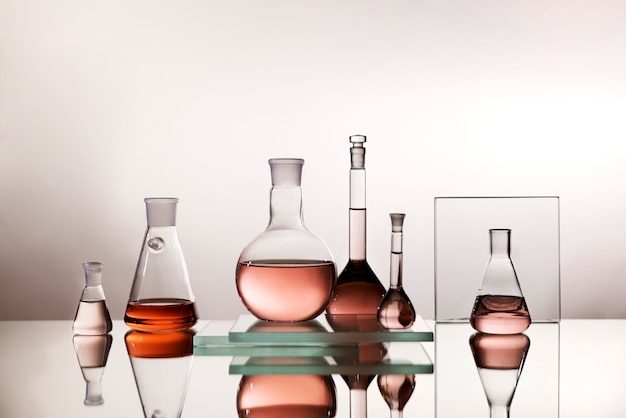 Free photo laboratory glassware with colored liquid arrangement