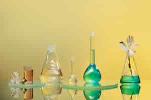 Free photo laboratory glassware with green liquid arrangement