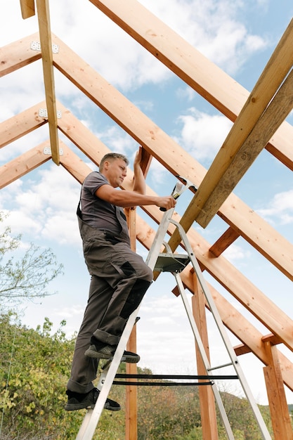 Laborer building the roof of the house