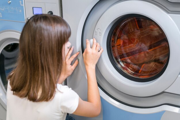 Lady closing washing machine door