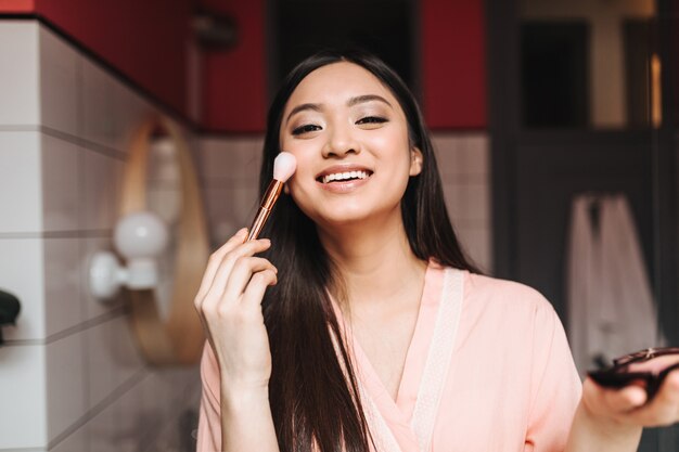 Lady in great mood doing day makeup
