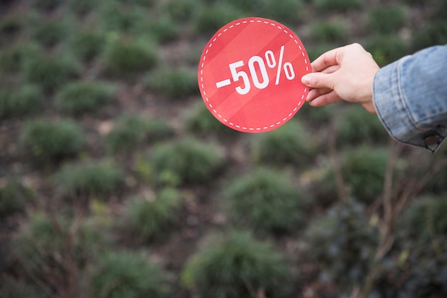 Lady holding red sale sign