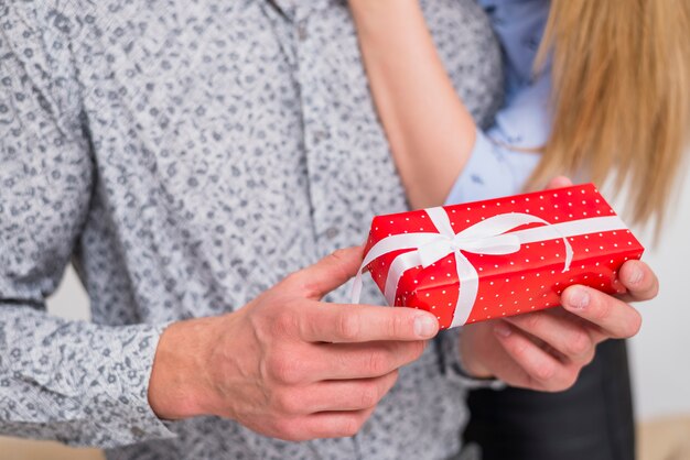 Lady hugging guy with red present box