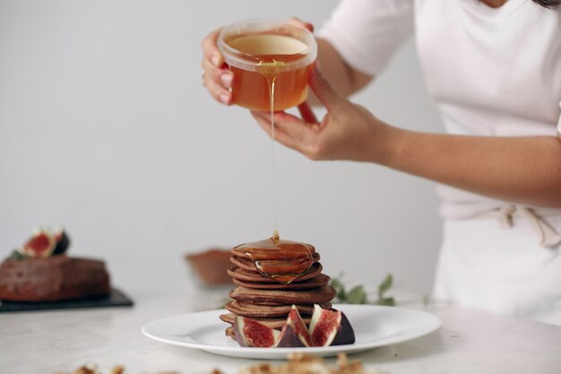 Lady is preparing dessert. Confectioner bakes a pancakes.Woman cooked food.