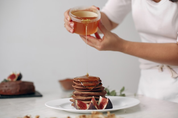 Lady is preparing dessert. Confectioner bakes a pancakes.Woman cooked food.