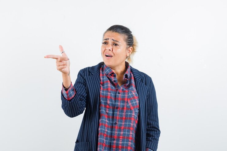 मुफ़्त फोटो lady pointing away in shirt, jacket and looking focused , front view.