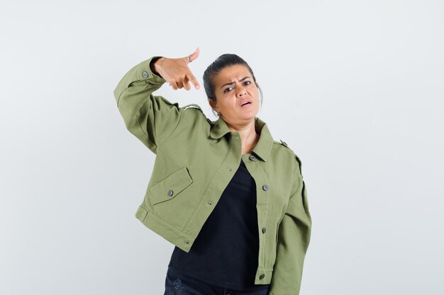 Lady pointing down in jacket