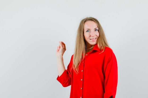 Lady in red shirt showing ok gesture and looking cheerful ,