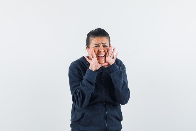 Lady shouting or announcing something in hoodie 