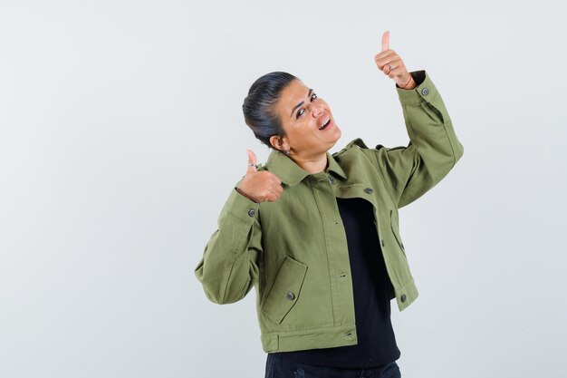 Lady showing double thumbs up in jacket