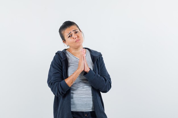 Lady showing namaste gesture in t-shirt