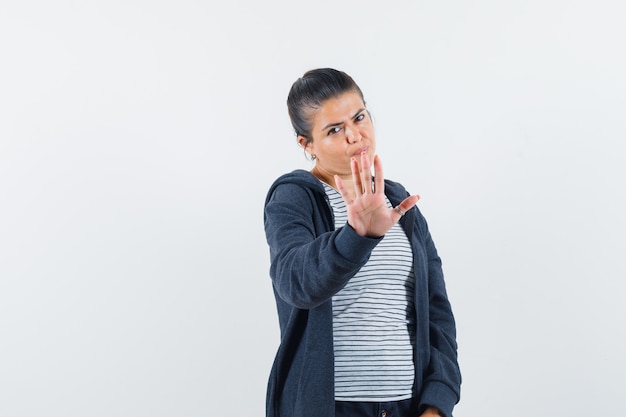 Lady showing stop gesture in t-shirt