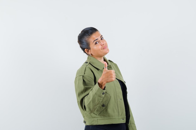 Free photo lady showing thumb up in jacket