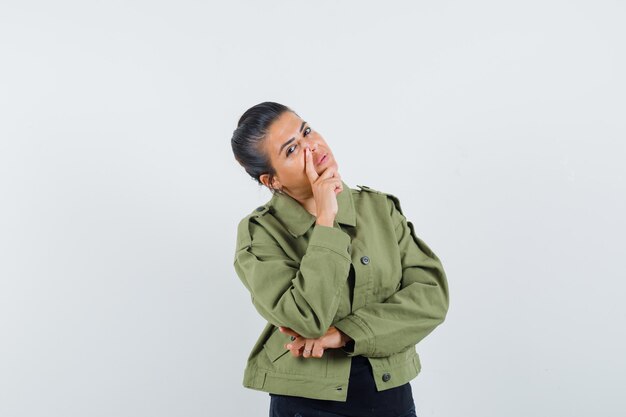 Lady standing in thinking pose in jacket