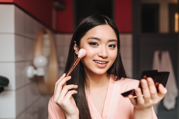 Lady with beautiful dark hair is smiling