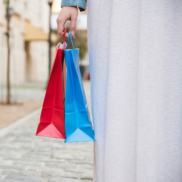 Lady with bright shopping packets on street