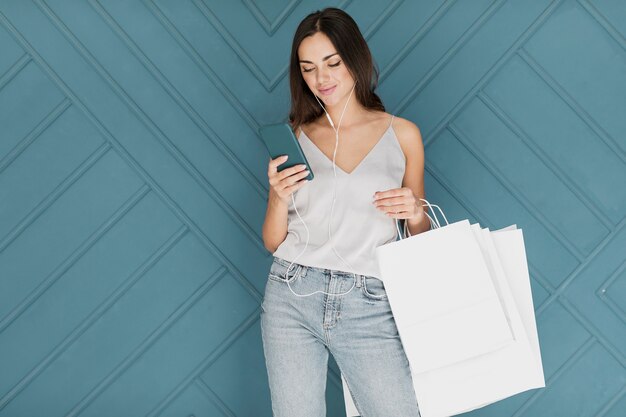 Lady with smartphone wearing blue jeans