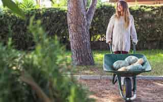 Free photo lady with vegetables in utility cart