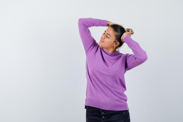 Free photo lady in wool blouse posing with hands on head and looking charming