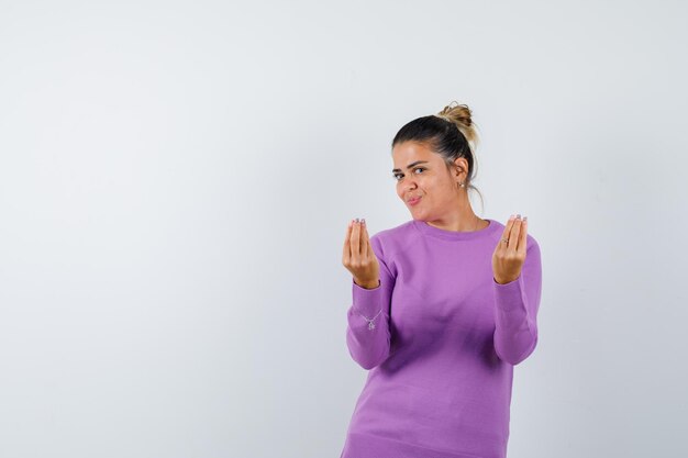 Lady in wool blouse showing Italian gesture and looking merry 