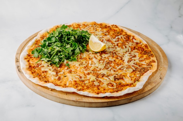 Lahmacun on lavash with lemon and parsley.