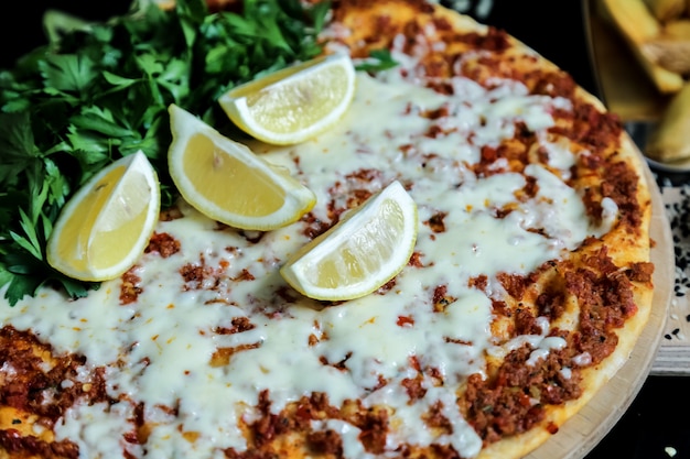 Lahmajun minced meat cheese parsley lemon side view