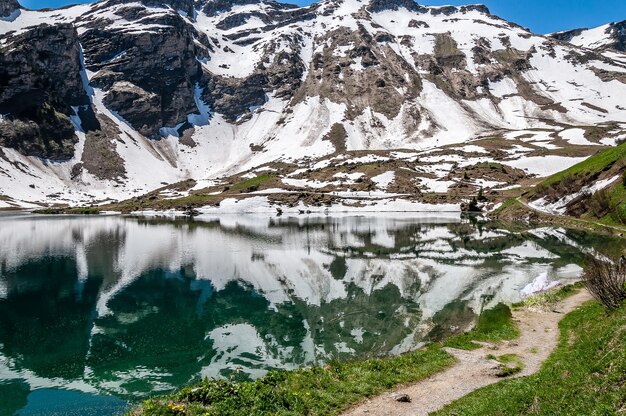 Lake Lac Lioson in Switzerland surrounded by mountains and snow