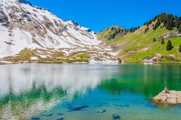 Lake Lac Lioson in Switzerland surrounded by mountains and snow