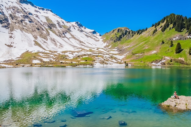 Lake Lac Lioson in Switzerland surrounded by mountains and snow