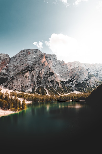 Lake near mountain under blue sky during daytime