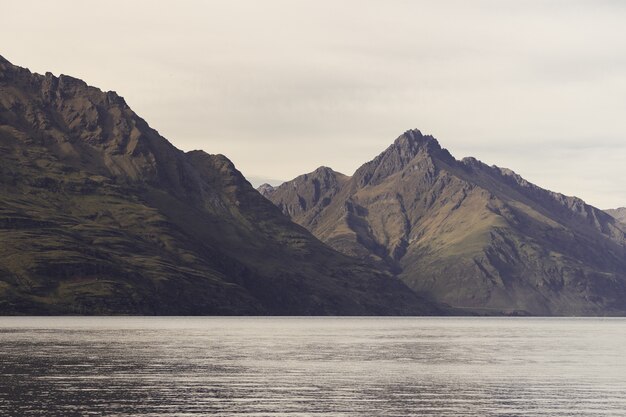 Lake surrounded by rocks under the sunlight in New Zealand