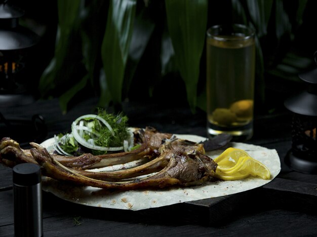 Lamb barbeque served in lavaash with fresh herbs and lemon slices