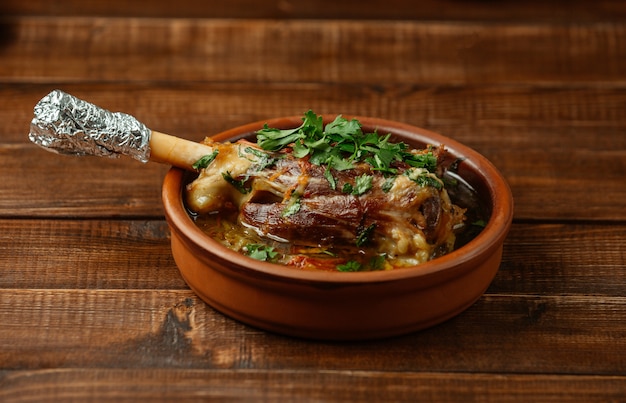 Lamb bone sauteed in bone broth with herbs and tomato sauce