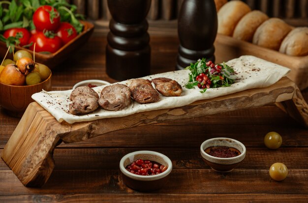 Lamb kebab served on a piece of lavash