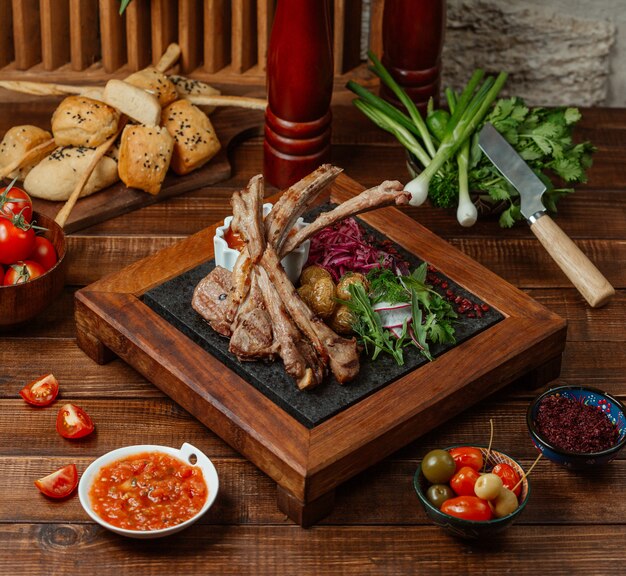 Lamb ribs kebab pieces served with baby potatoes, herbs and raddish salad