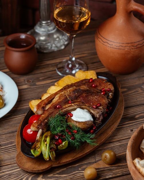 lamb steak with fried potatoes, grilled peppers, tomato and fresh dill