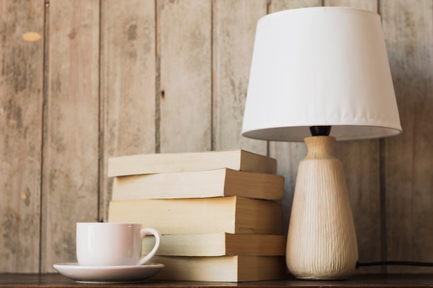 Lamp coffee and pile of books