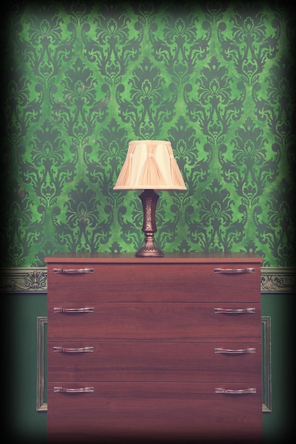 Lamp holder in green vintage interior with vignette. Rococo pattern. Old rich luxury interior