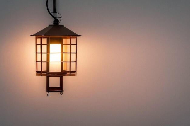 A lamp on a wall with a light on it