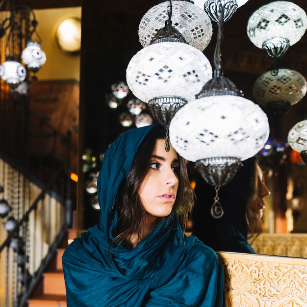 Free photo lamps and woman in arab restaurant