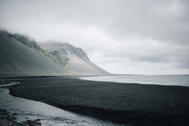 Landscape of black sandy volcanic beach