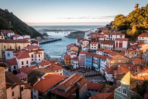 Landscape of Cudillero surrounded by hills and sea under the sunlight in Spain