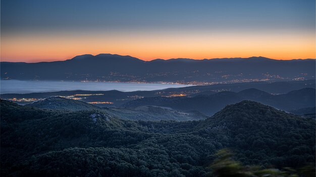 Landscape of mountains covered in greenery in Rijeka and Opatija during the sunrise in Croatia