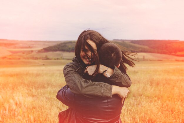 Landscape portrait of young beautiful stylish couple sensual and having fun outdoor