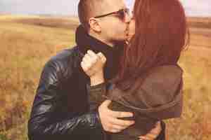 Free photo landscape portrait of young beautiful stylish couple sensual and having fun outdoor