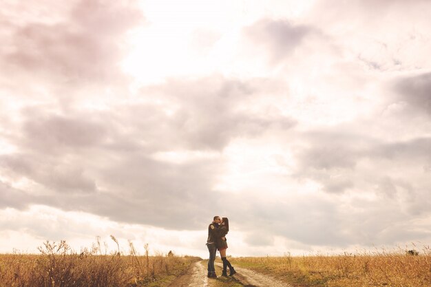 Landscape portrait of young beautiful stylish couple sensual and having fun outdoor